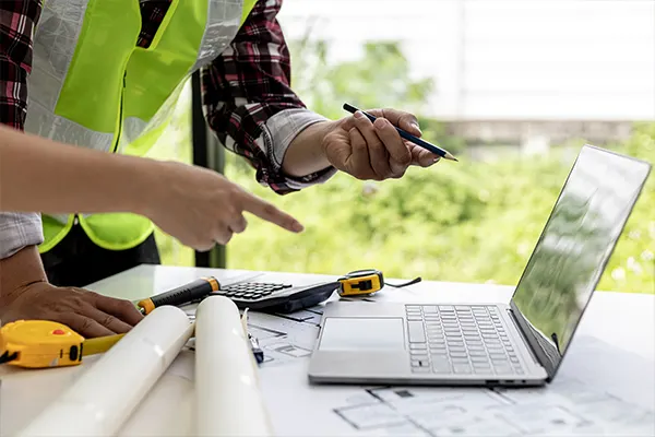 Laptop with tape measure and calculator