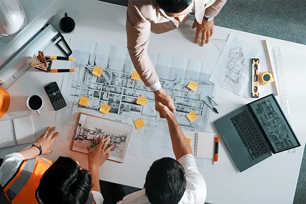Construction-workers-shaking-hands-Indoors-Laptop