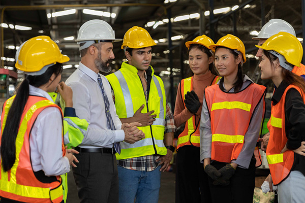Seven construction workers standing and talking THUMBNAIL