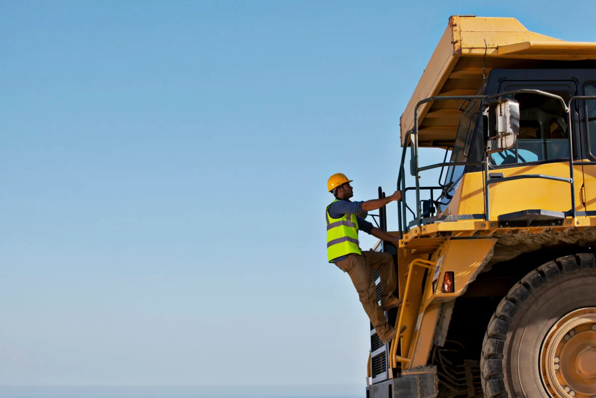 Construction worker on a large dump truck