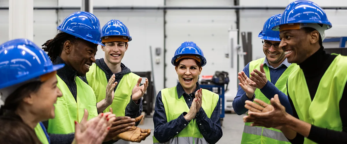 Six construction workers happy and clapping