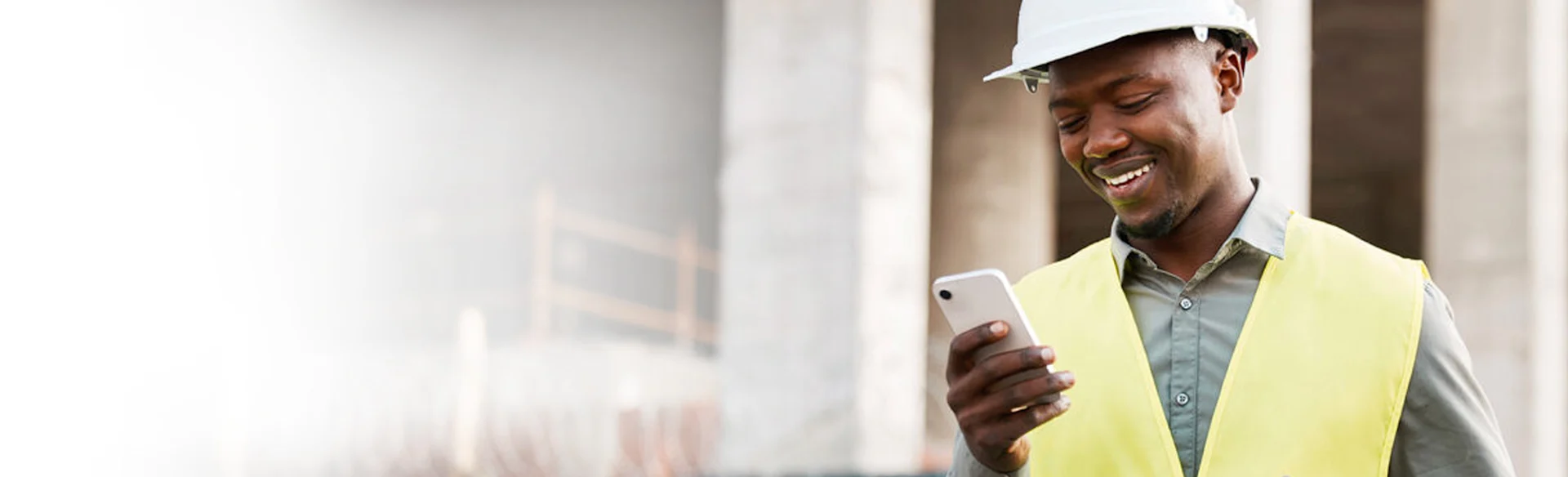 Construction worker looking at his iPhone - Construct CT Webinar Landing Page Image Cropped 1200x352