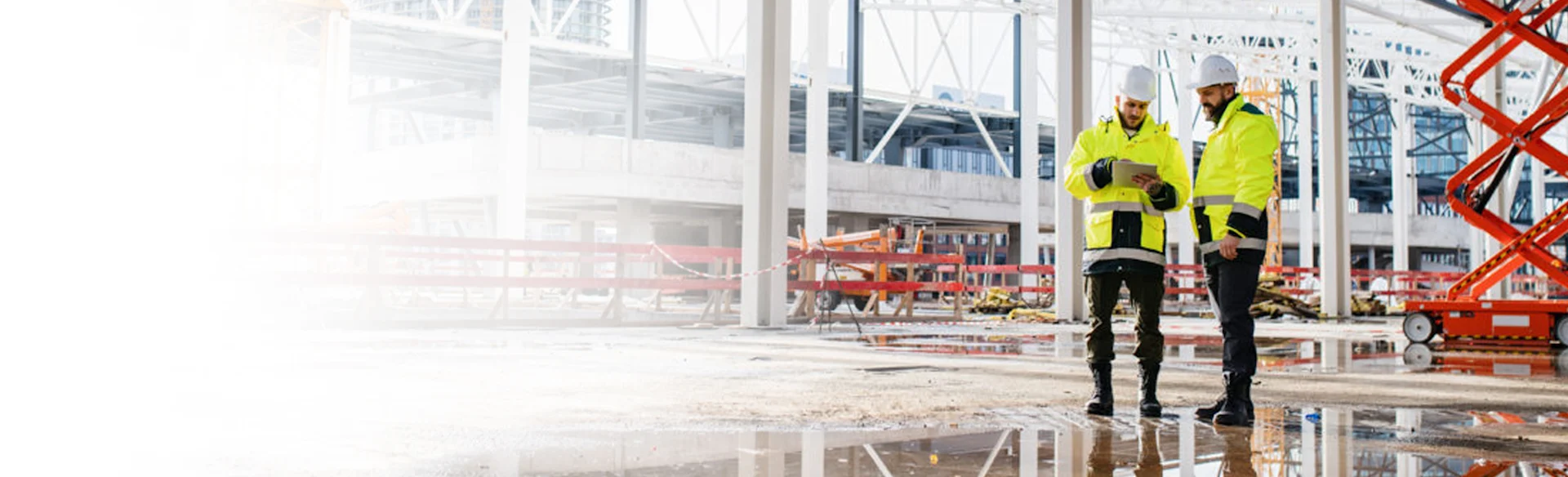 Two construction executives looking at an iPad on a site 1200x800