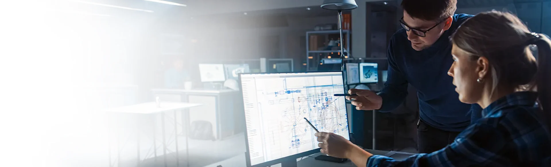 Two employees looking at a monitor