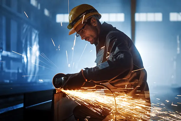 Man-BlueOveralls-ConstructionSite-FireSparks THUMBImage