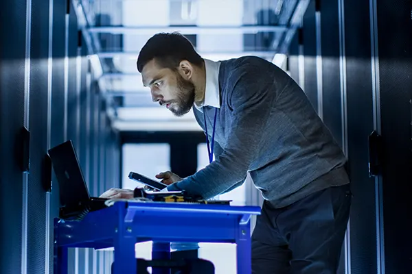 Man-Indoors-BlueDesk-Typing THUMBImage