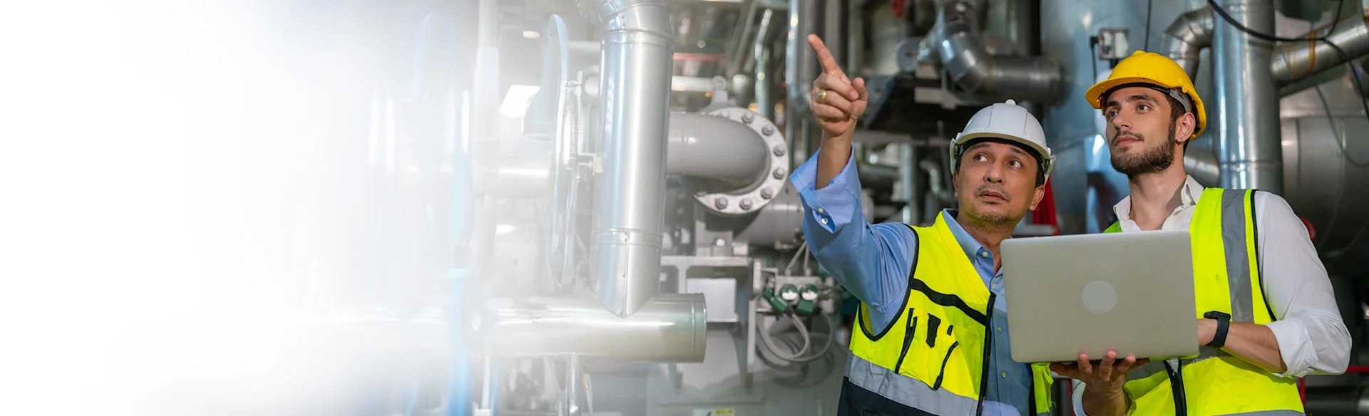 two construction workers and one is pointing upward