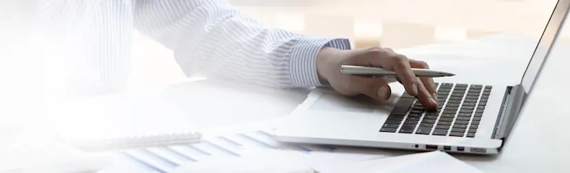 businessman-typing-working-laptop-finance HEROImage