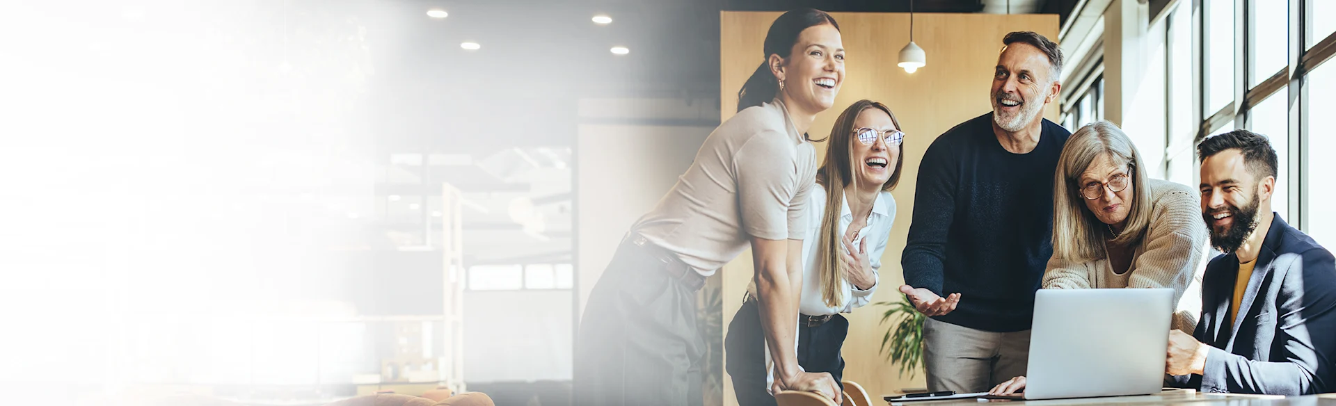 PeopleSmiling-Indoors-Laptop-Table HEROImage