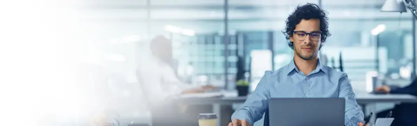 Male employee looking at desktop HERO - 5120 x 2880