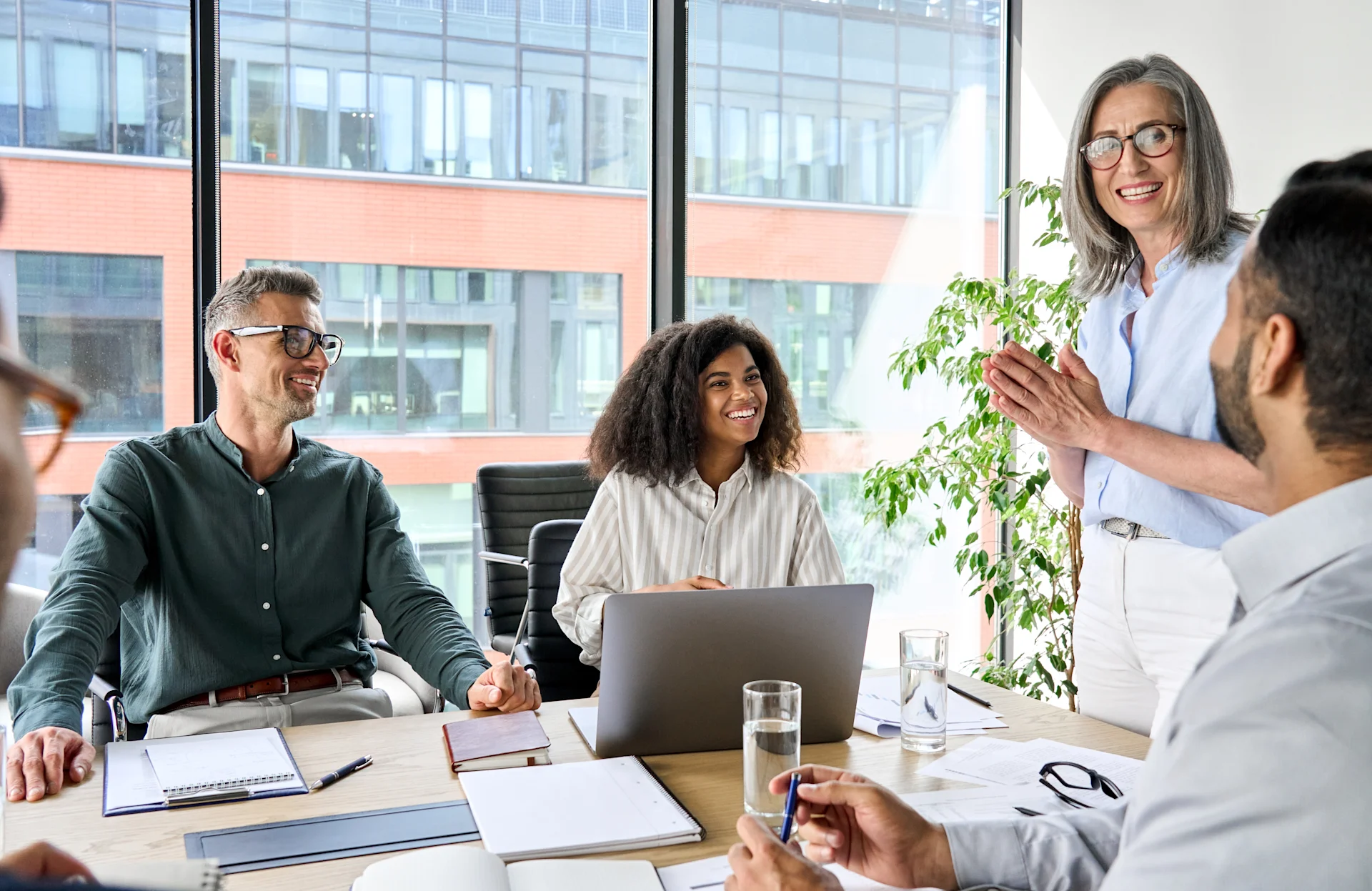 Three employees listening to someone talk