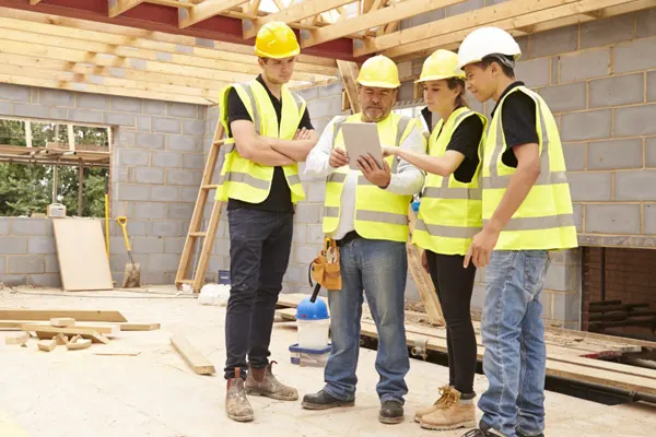 Four construction workers looking at an iPad - THUMBNAIL