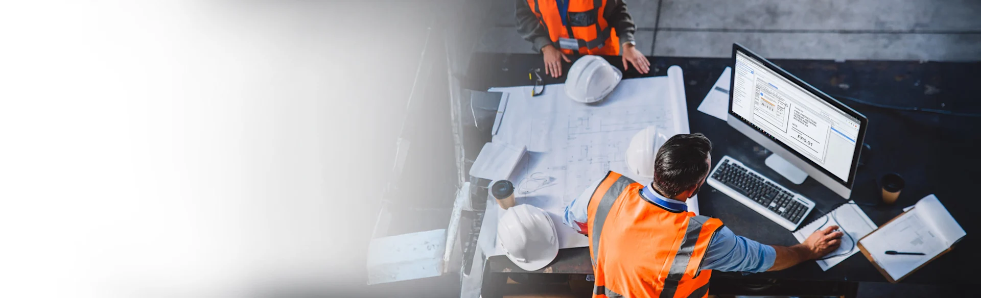 overhead shot of construction worker looking at monitor