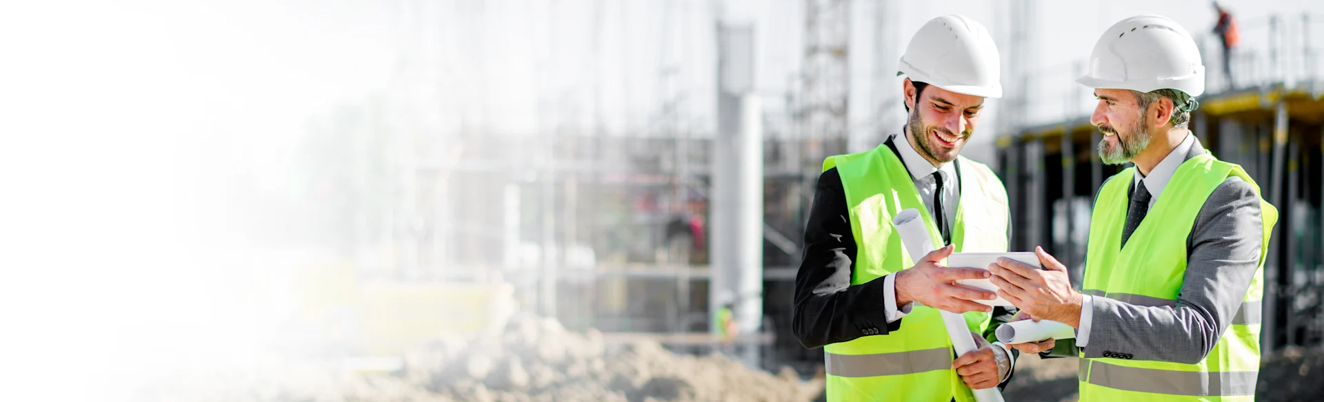Two construction executives looking at an iPad on a site