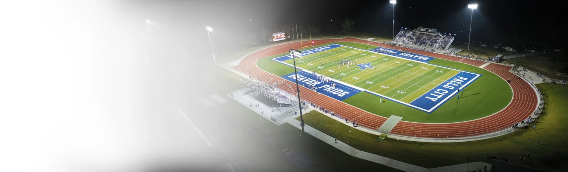 Football stadium falls city at night 1200x675