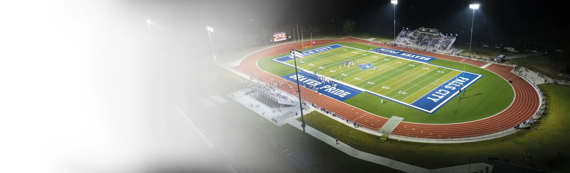 Football stadium falls city at night 1200x675