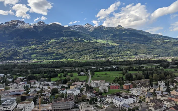 A view of a town with mountains in the background.