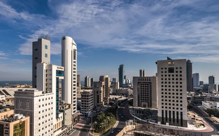 A view of a city with tall buildings and a blue sky.