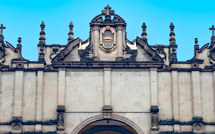 An ornate building with a cross on top.