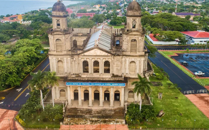 An aerial view of a church near the ocean.