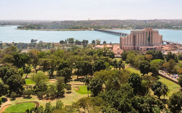 An aerial view of a city with a river in the background.