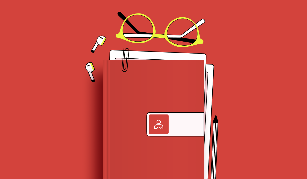 A notebook with glasses and a pen on a red background.
