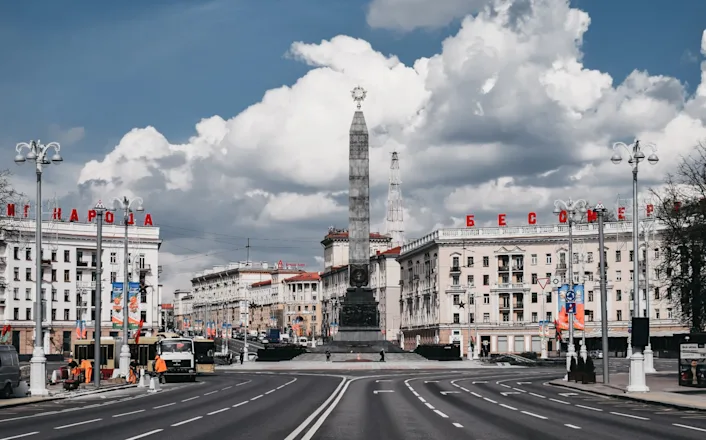 An empty street with a monument in the middle.