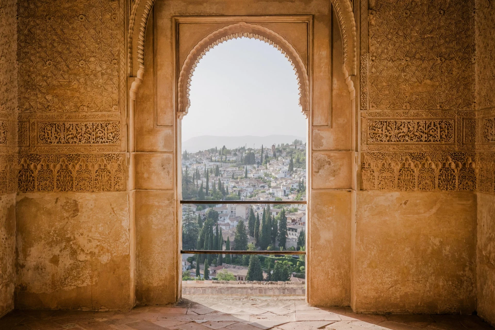 A view from an arched window in a building in granada, spain.