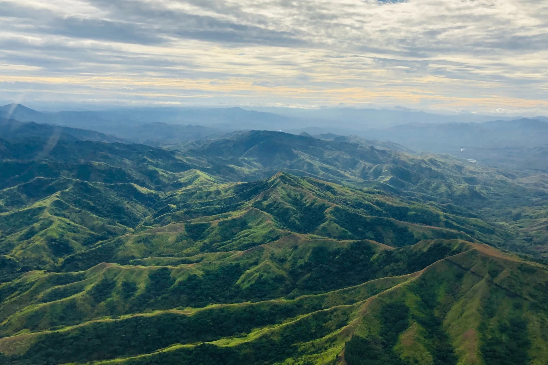 An aerial view of a green mountain range.