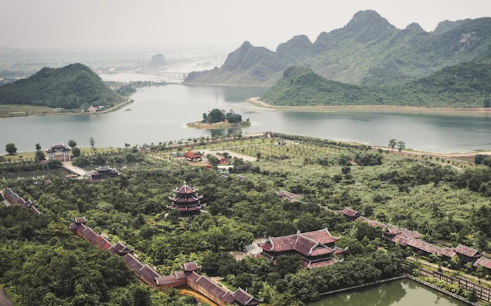 An aerial view of a lake and mountains.