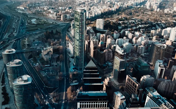 An aerial view of a city with tall buildings and a highway.