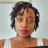 A woman with dreadlocks and pink lipstick.