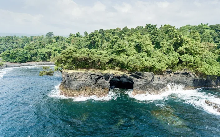 An aerial view of a rocky island in the ocean.