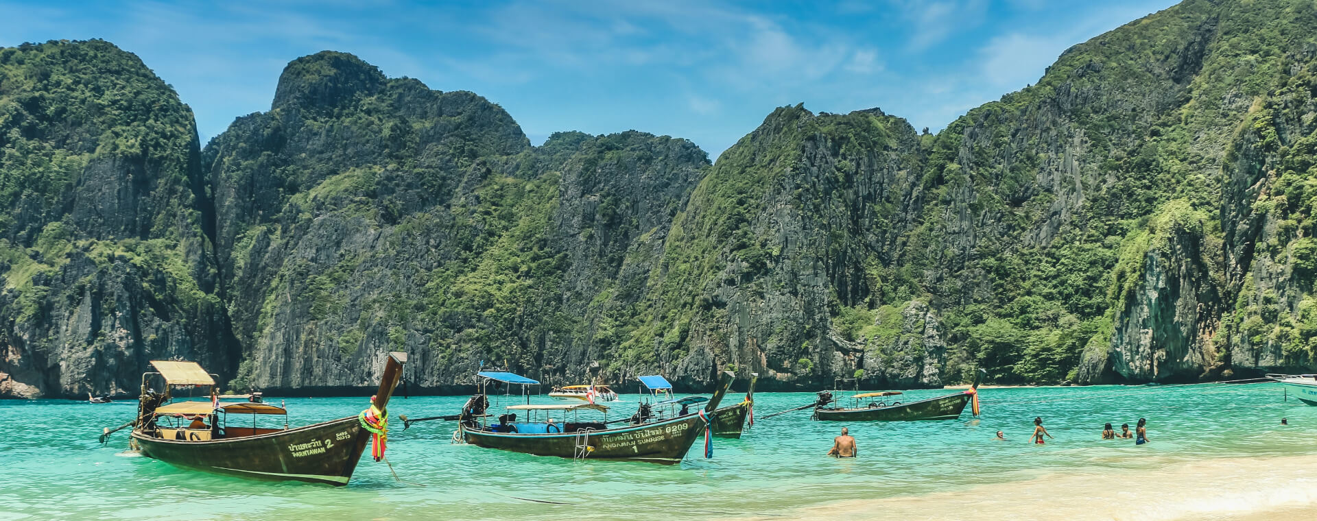 Boats docked on a beach in thailand.