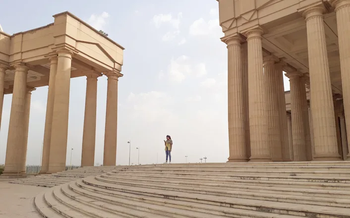 A person standing on the steps of a building.