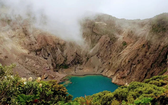 A crater with a blue lake in the middle.