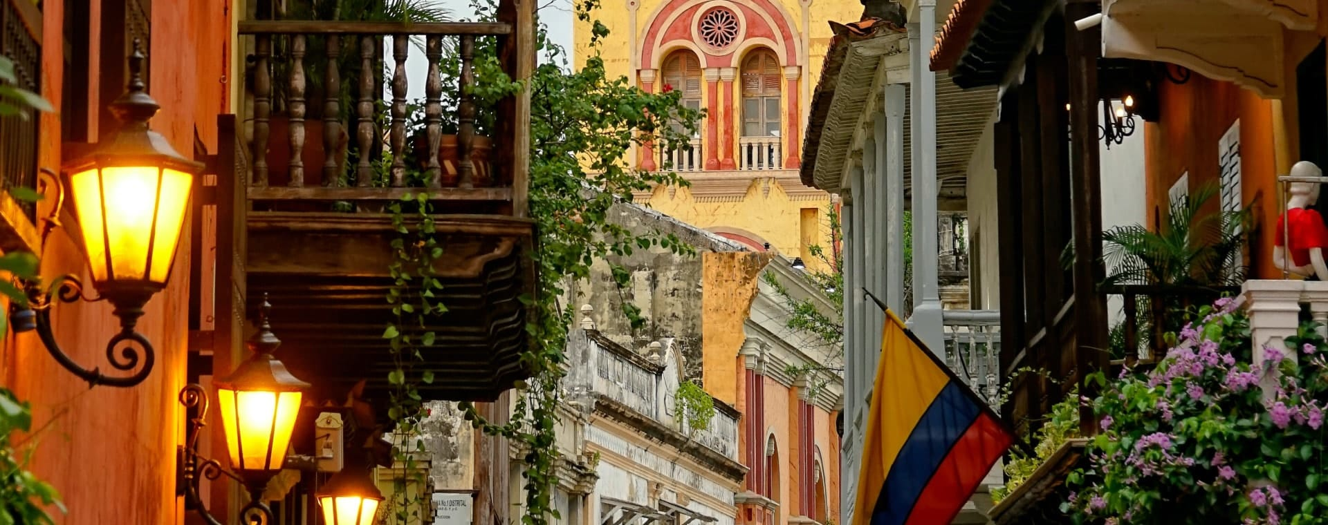A narrow street in colombia with colorful buildings.