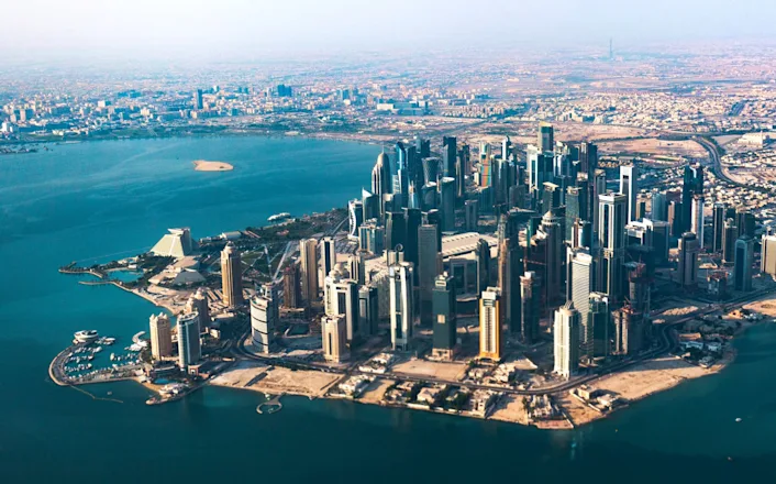 An aerial view of a city in the middle of a body of water.