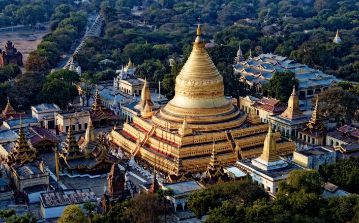 An aerial view of a golden pagoda in myanmar.