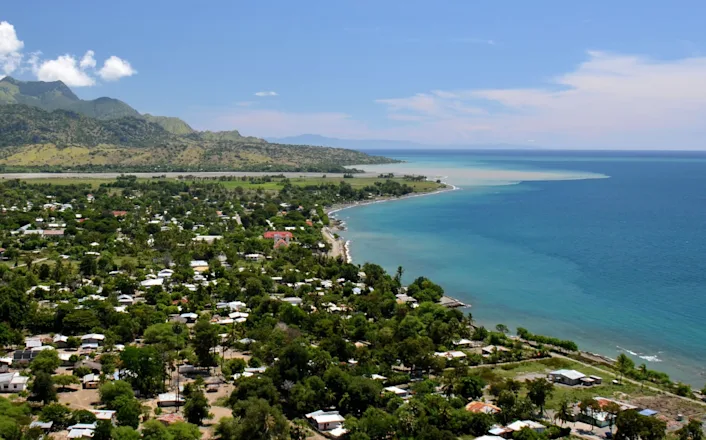 An aerial view of a town near the ocean.