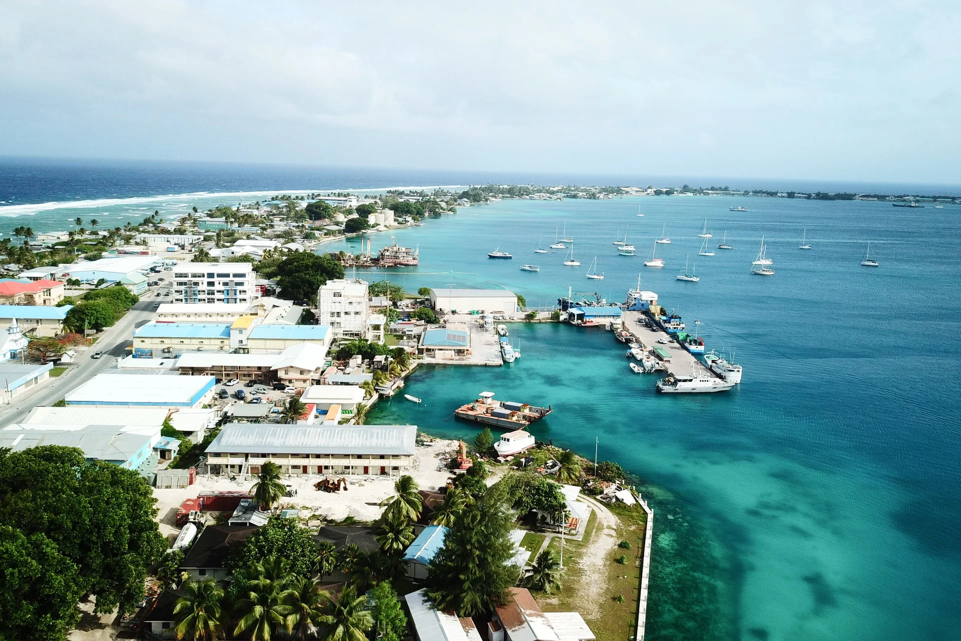 An aerial view of a town with boats in the water.