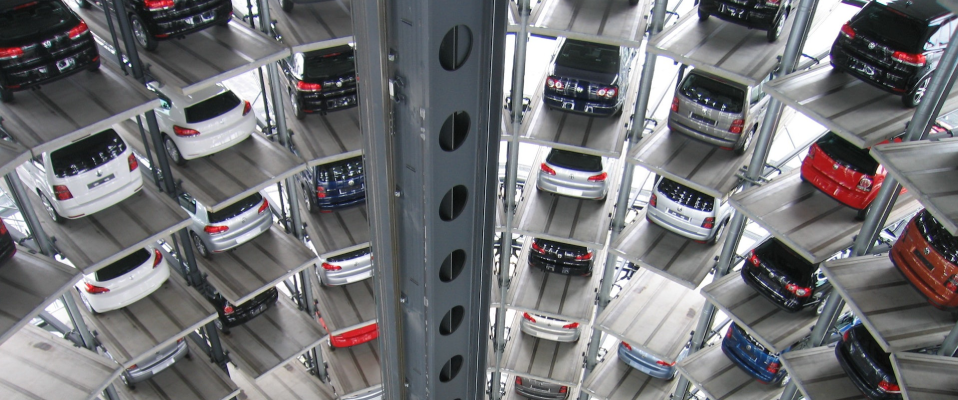 A photo of a tiered, circular garage filled with cars