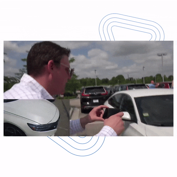 Car salesman recording covideo of a car to customer