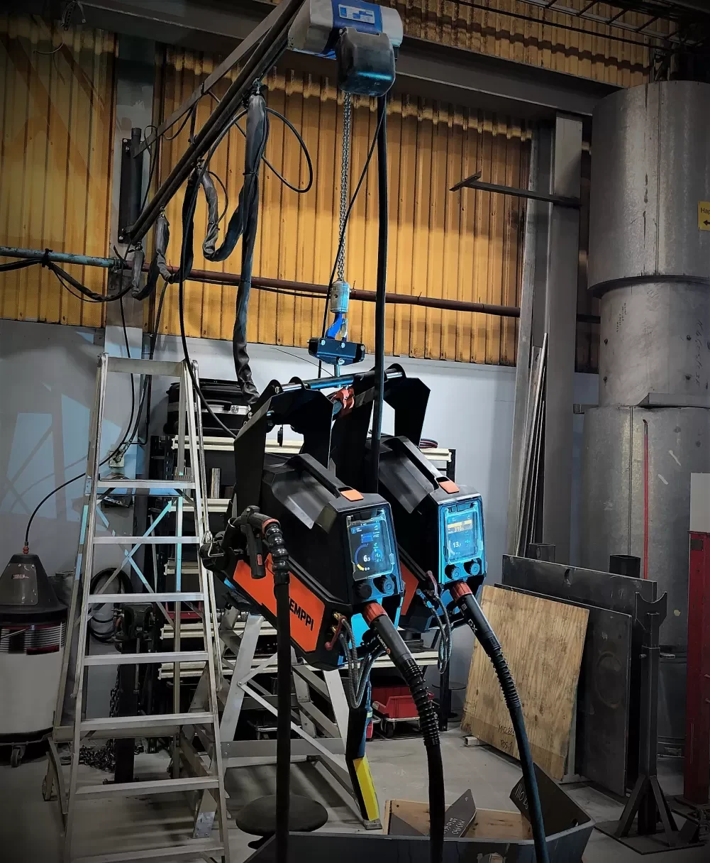 Hanging up the wire feeders in a dual setup significantly speeds up daily welding production.