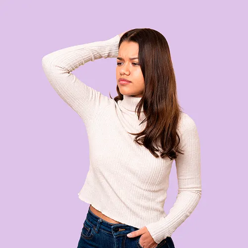 Worried woman looking down with the message vaginal discharge