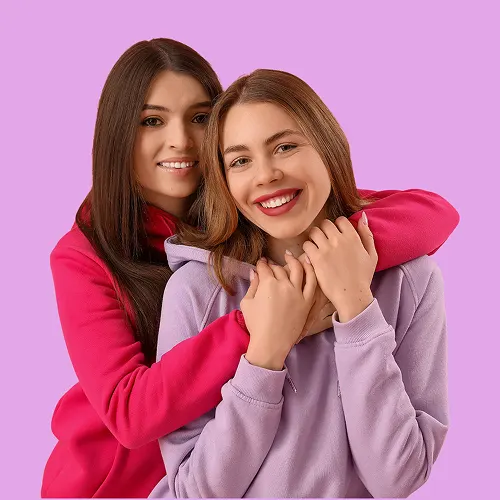 Smiling and hugging young women with the message first period and puberty