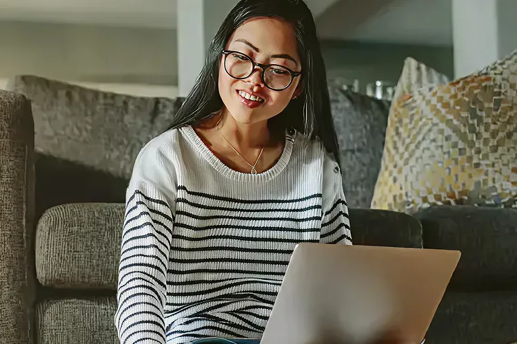 Una chica estudiando en un portátil.