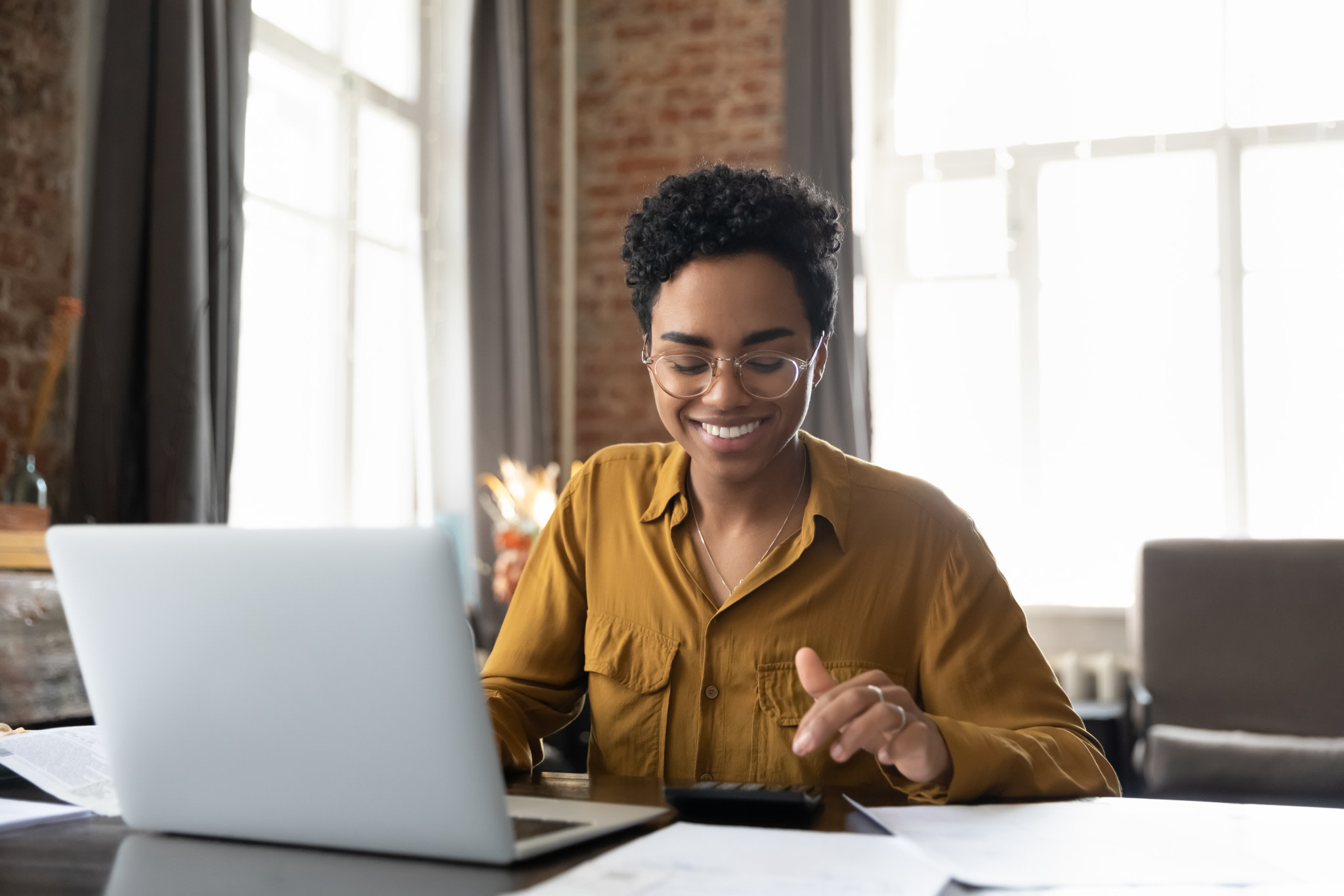 A woman at a desk with a laptop.