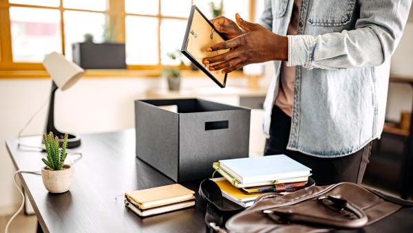 Person packing their desk.