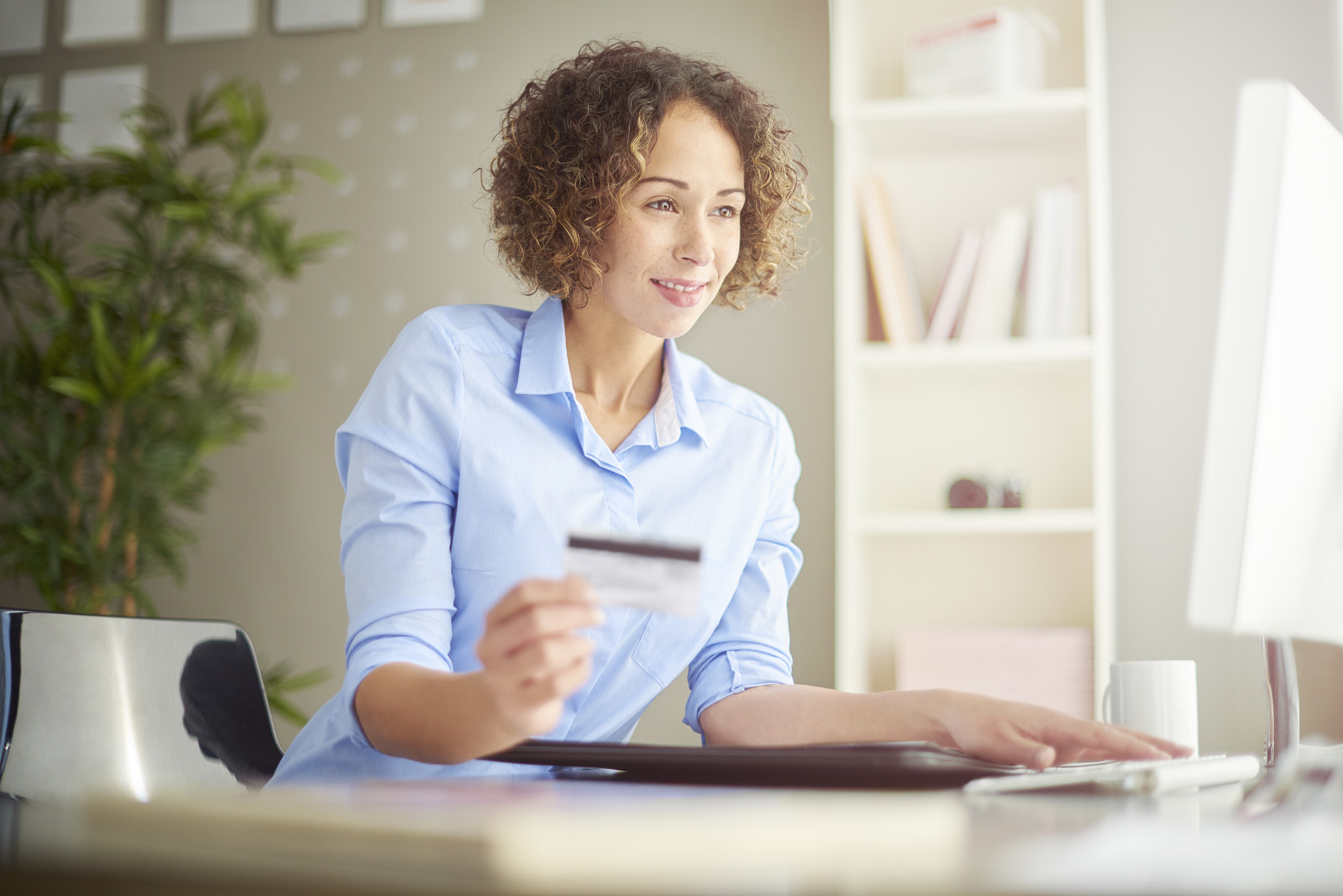 A businesswoman with a card.